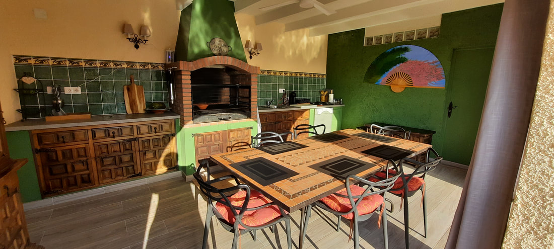 Outdoor kitchen with green tiled backsplash