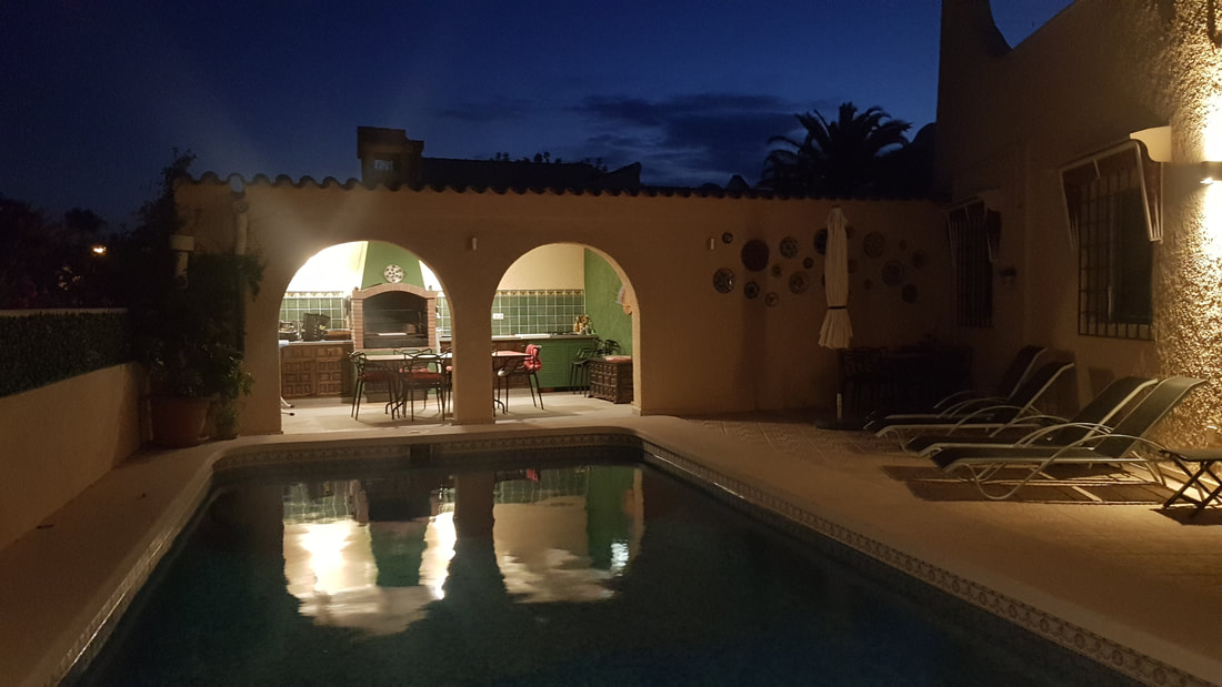 Outdoor kitchen lit up in the evening