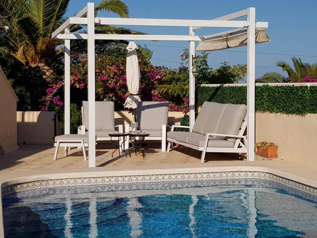 Shaded lounge area beside the pool